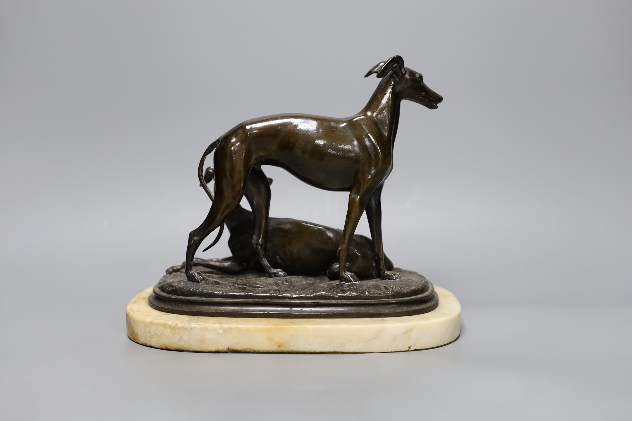 A 19th century patinated spelter greyhound group, unsigned, on alabaster plinth, 20cm high